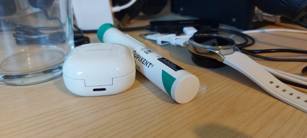 Autoinjector nestled between other objects